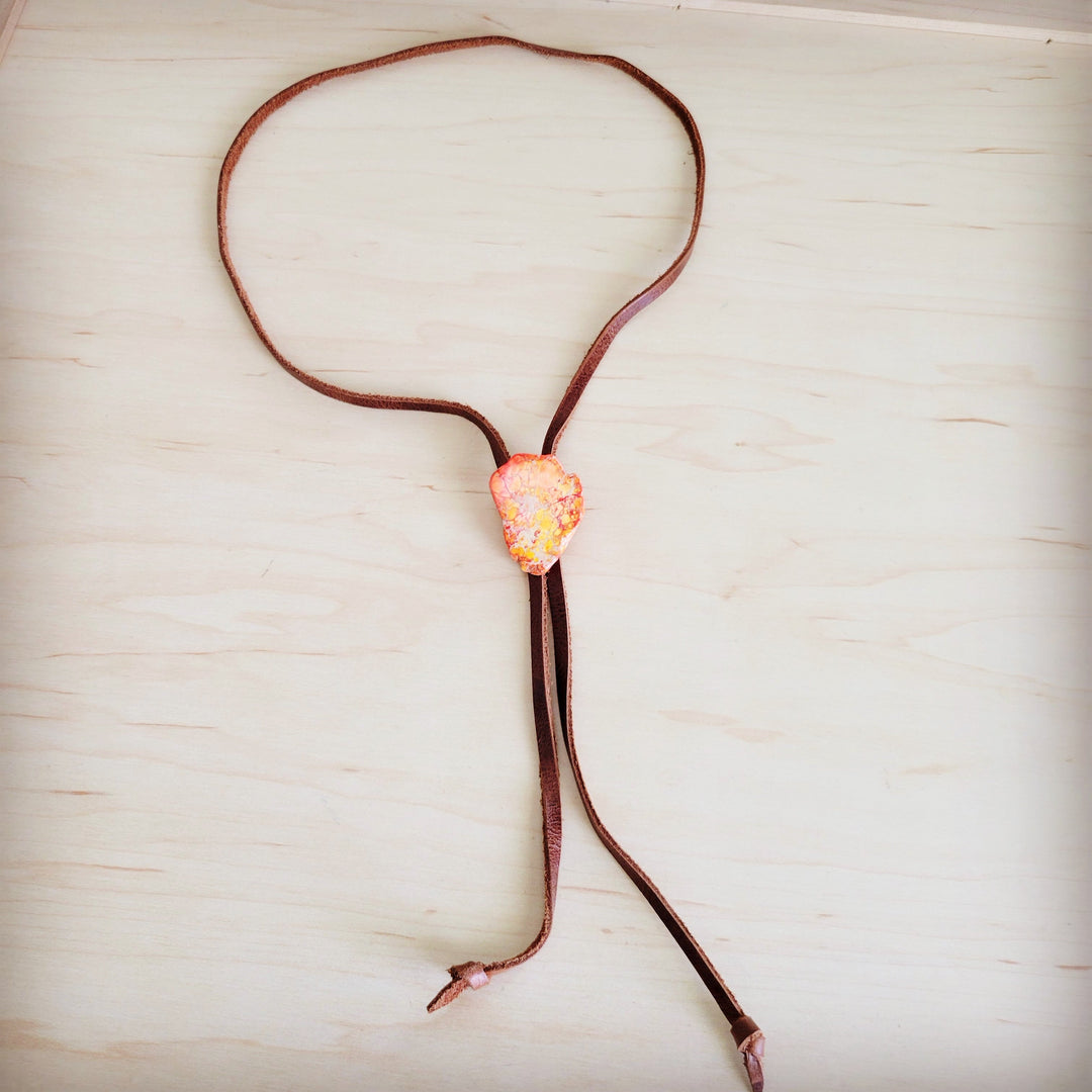 Leather lariat necklace with orange Regalite slab pendant on brown cord
