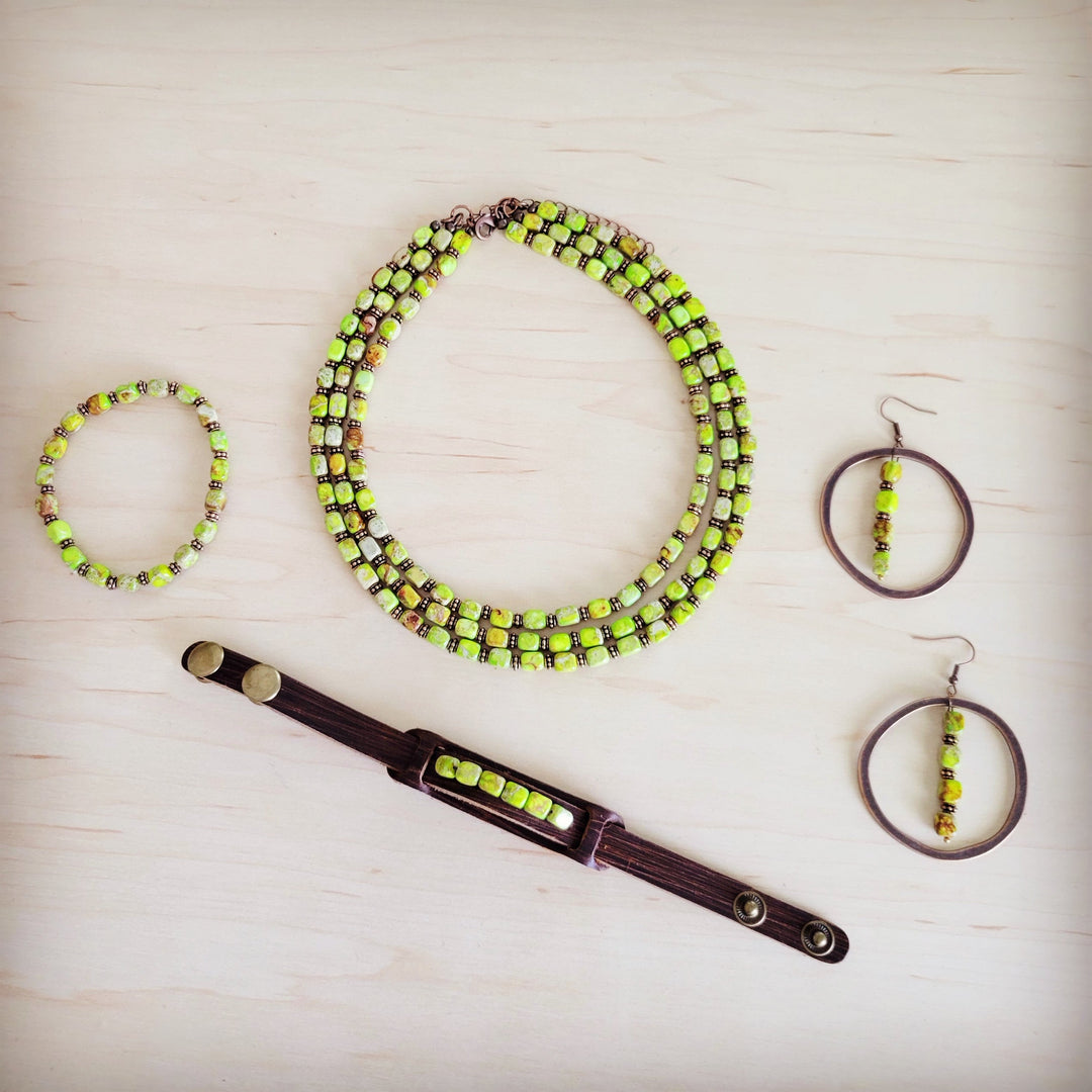 Layered lime green beaded necklace with matching earrings and bracelet on display