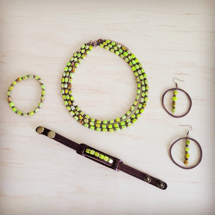 Layered lime green beaded necklace with matching earrings and bracelet on display