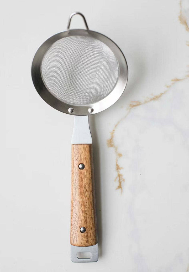 Round mesh strainer with dark metal rim and fine mesh screen, long wood handle