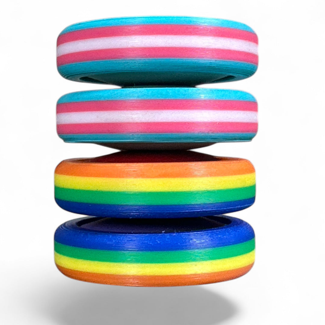 Stack of pride rainbow striped round bands in turquoise, pink, orange, green, and blue