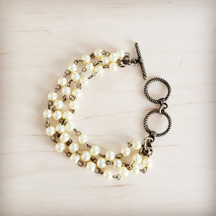 Champagne pearl triple-strand beaded bracelet with heart toggle clasp