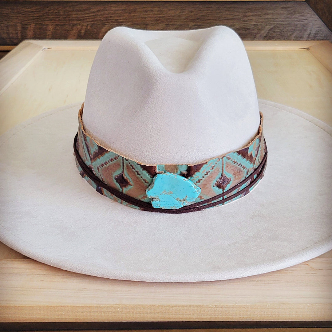 White felt cowboy hat with wide turquoise leather band and central turquoise stone