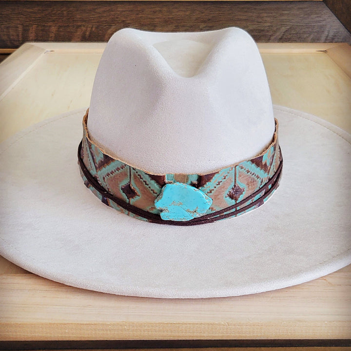 White felt cowboy hat with wide turquoise leather band and central turquoise stone