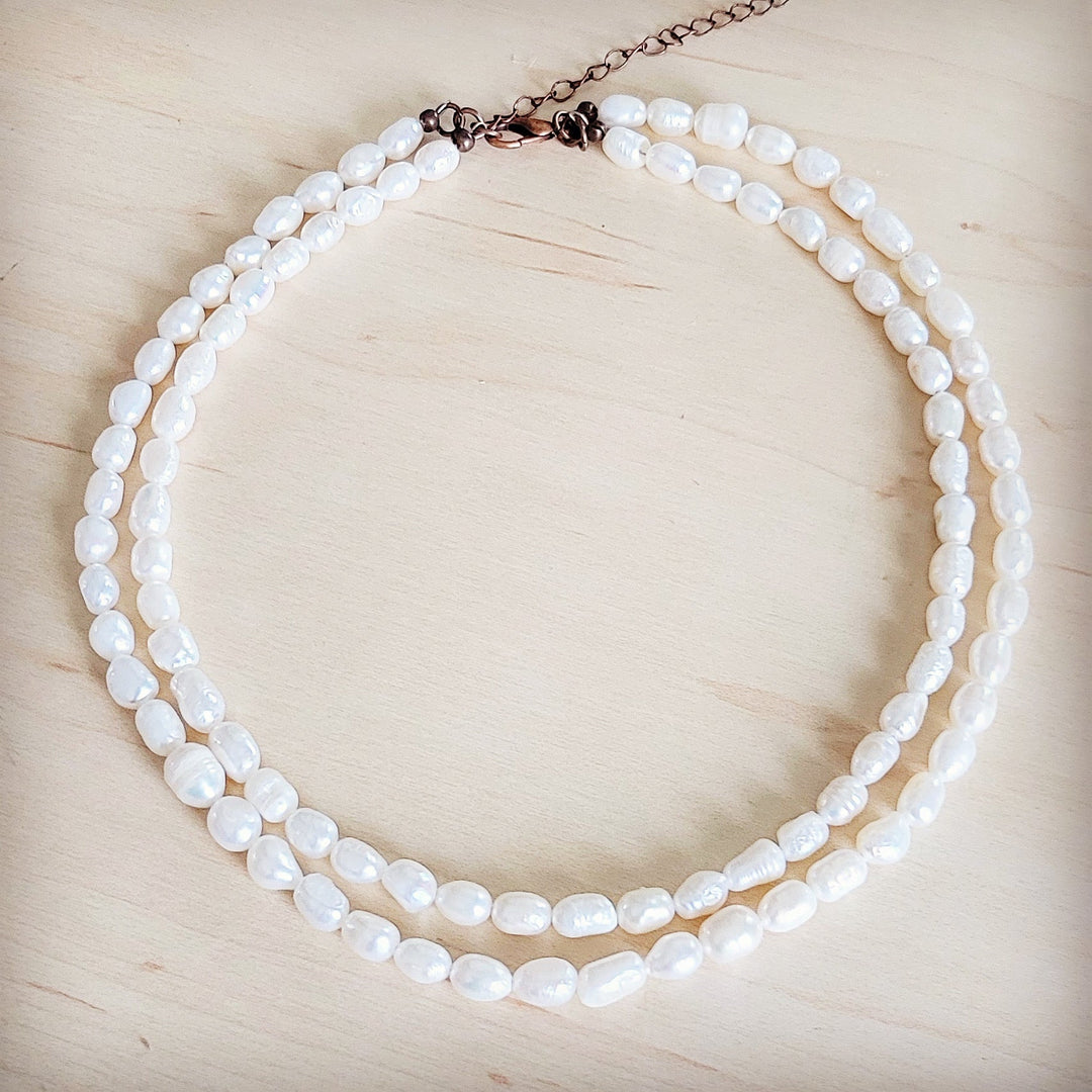 Double-strand freshwater pearl necklace with rose-tone clasp and short chain