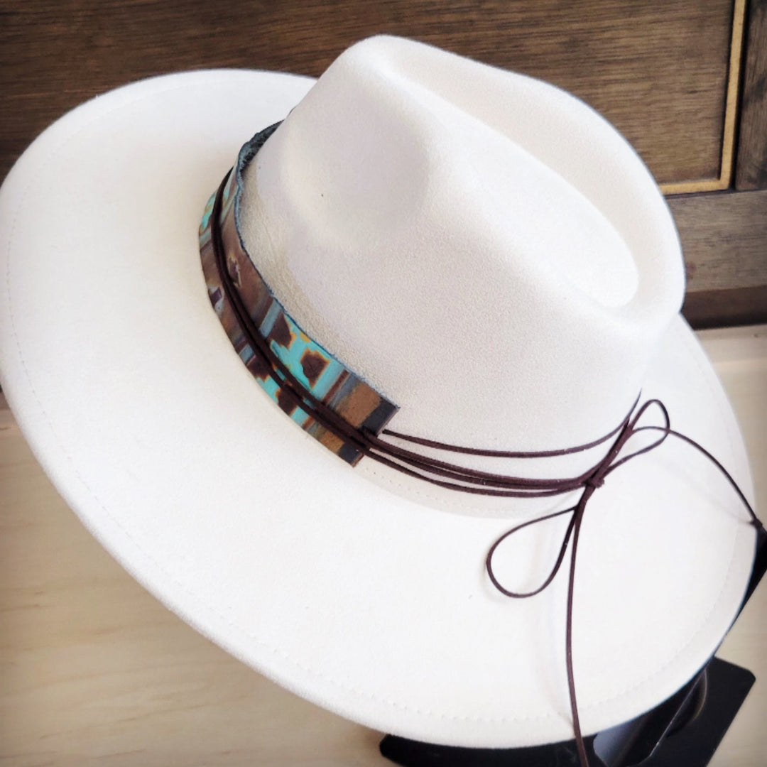 White felt hat with wide leather Navajo hat band and long tie strings