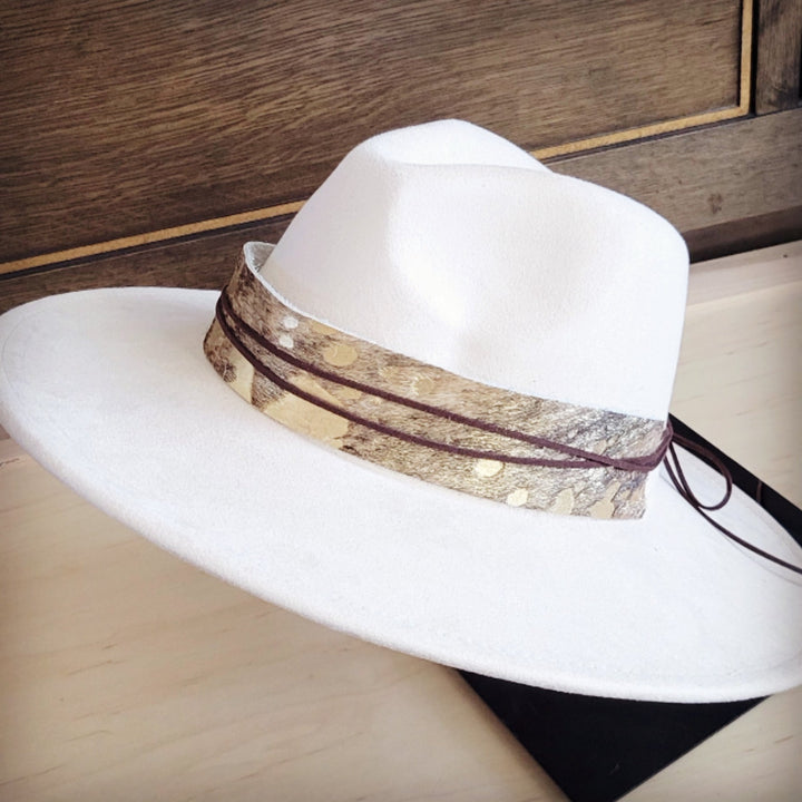 White wide-brim felt hat with brown metallic-speckled band and dangling dark tie strings