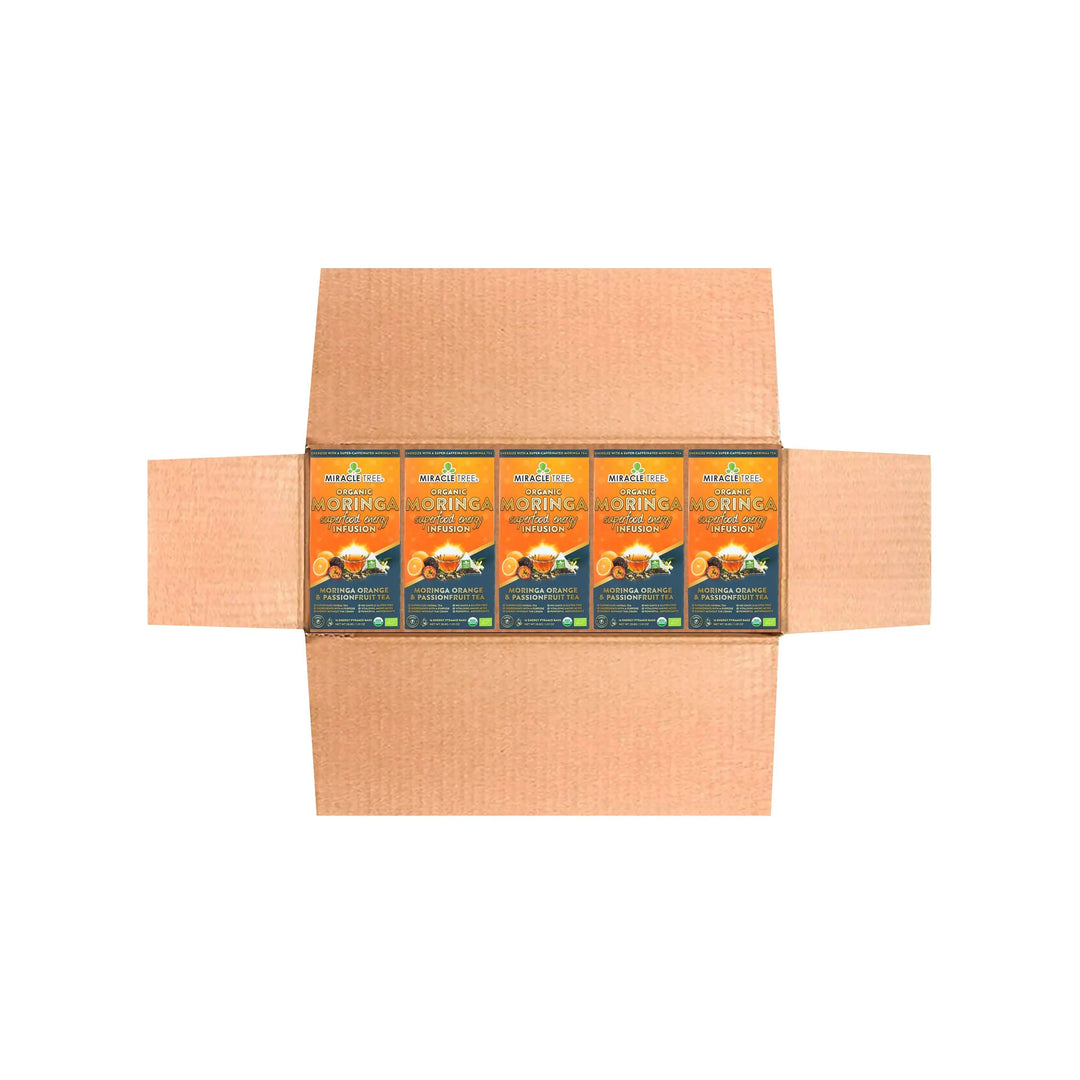 Cardboard shipper holding multiple Miracle Tree Organic Moringa tea pouches in a row