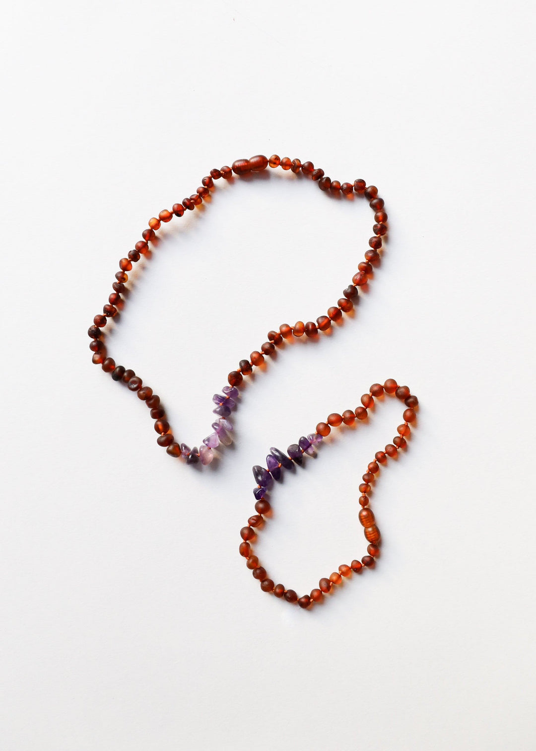 Raw amber and amethyst beaded necklace, flat lay with matching strand drape