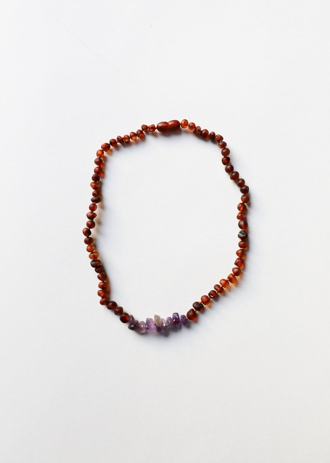 Raw amber and amethyst beaded necklace, full heart-drop shape on white