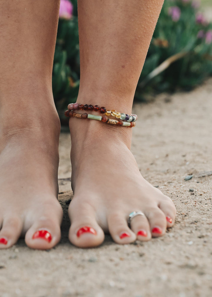 Beaded anklet bracelet with amber-brown beads and small rainbow stone accents