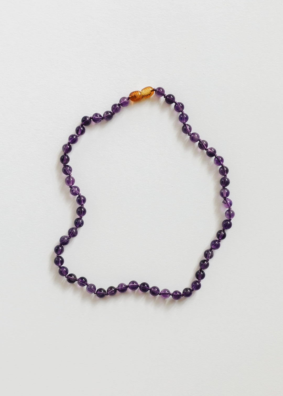 Amethyst bead necklace with orange spacer beads at the top