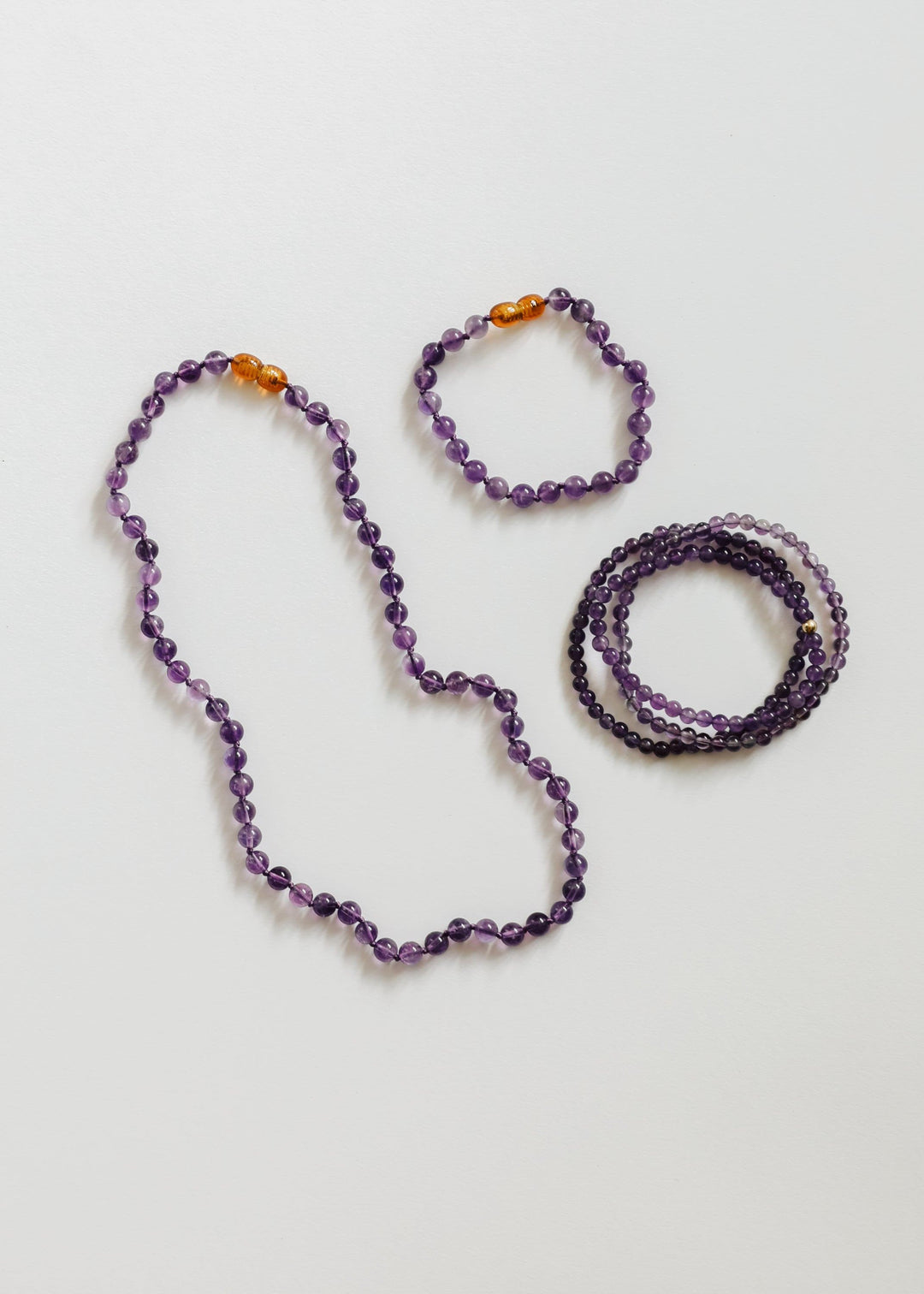 Amethyst bead necklace and matching bracelets with orange bead accents