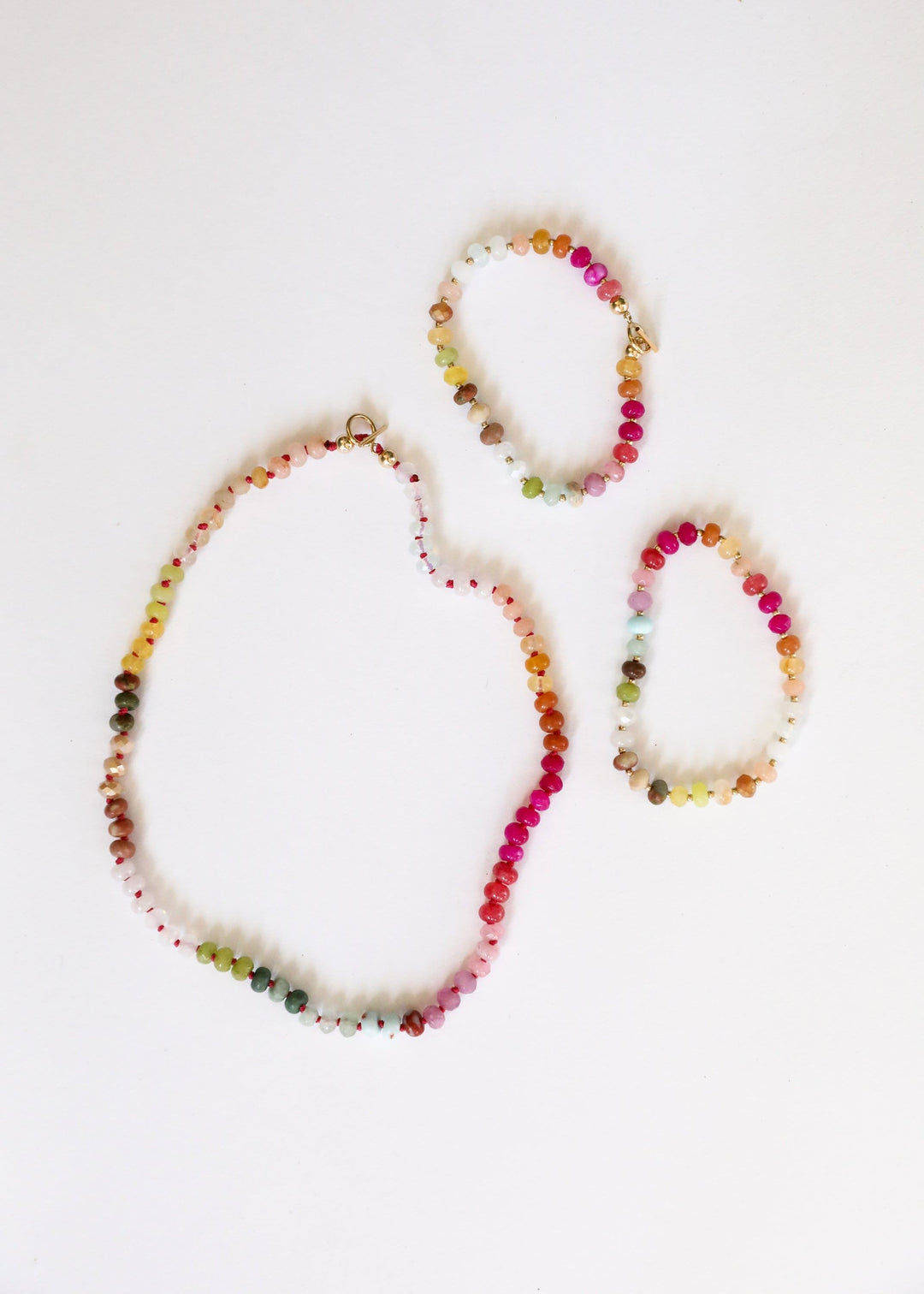 Three multicolor gemstone bead necklace strands with gold-tone accents