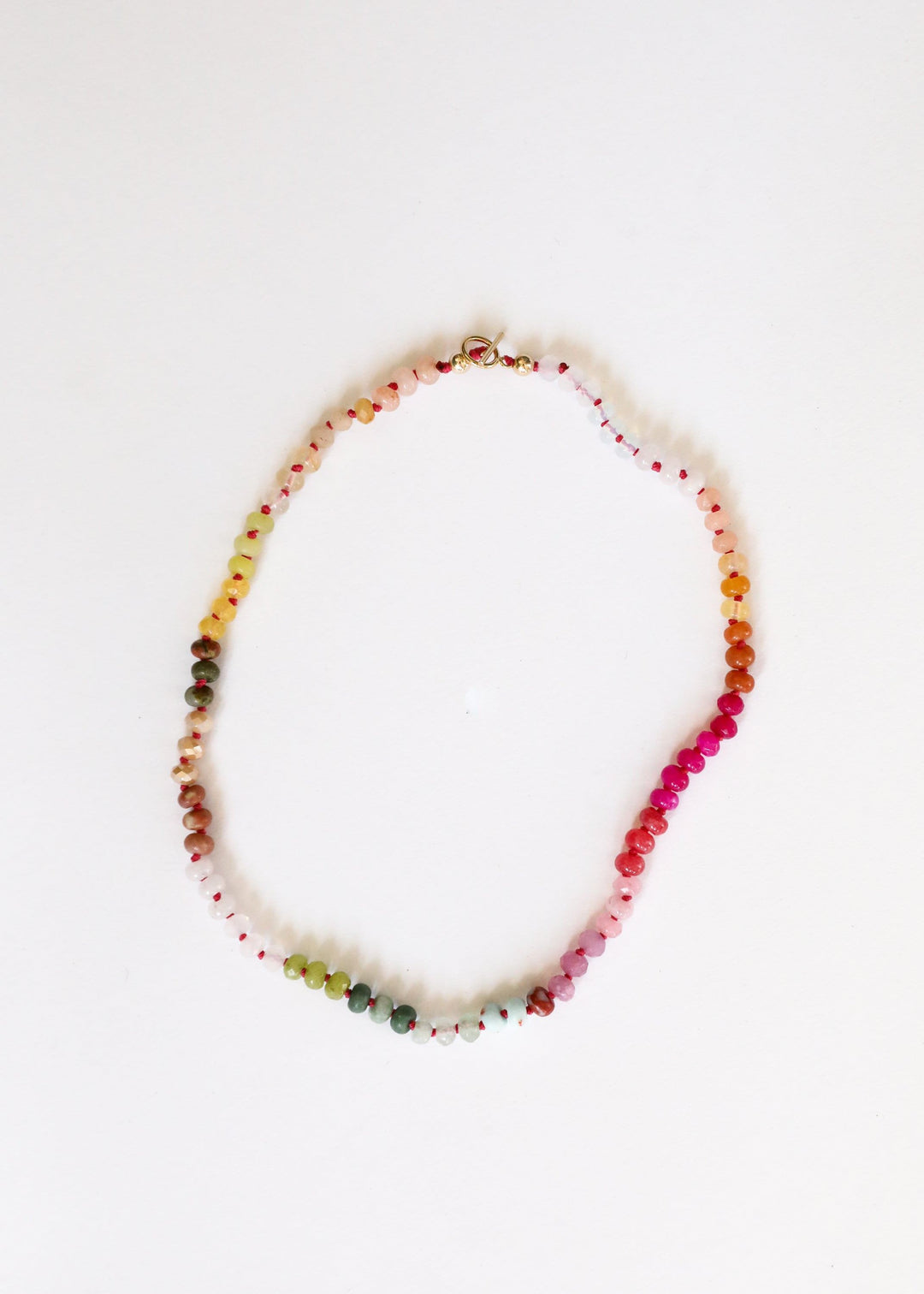 Multicolor gemstone bead necklace strand with gold-tone accents