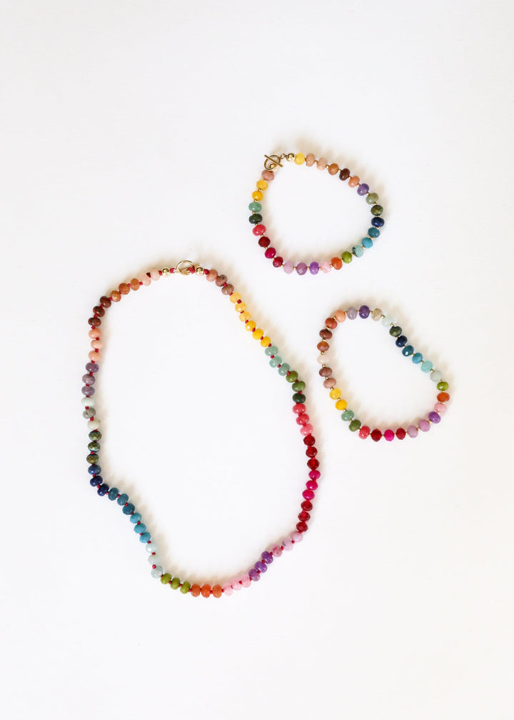 Three multicolor beaded gemstone necklaces with gold-tone clasp hardware