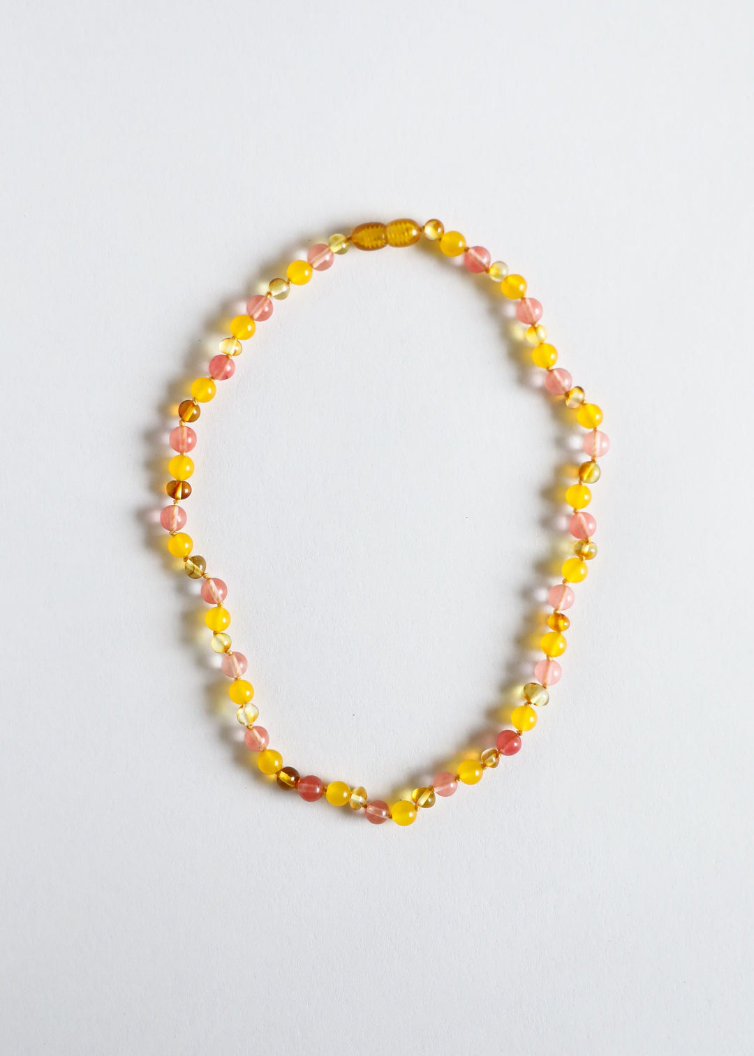 Beaded necklace with golden yellow and pink gemstone beads, oval and round bead pattern