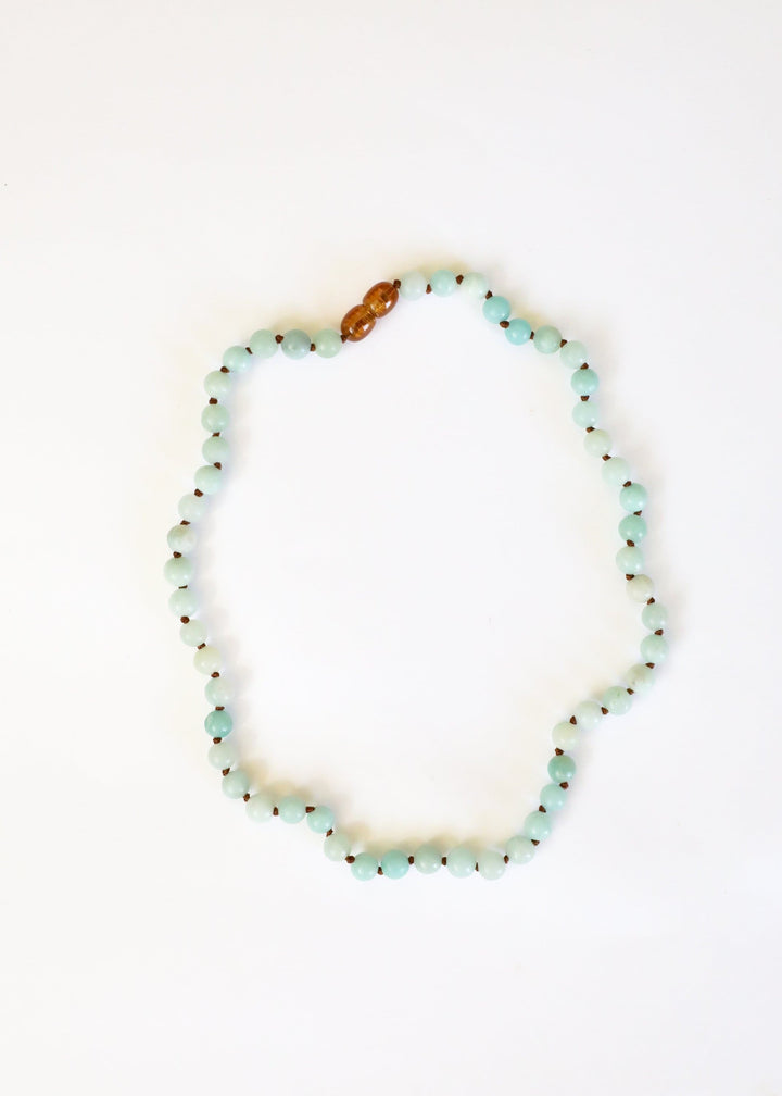 Amazonite beaded necklace, light blue round beads with a single amber accent bead