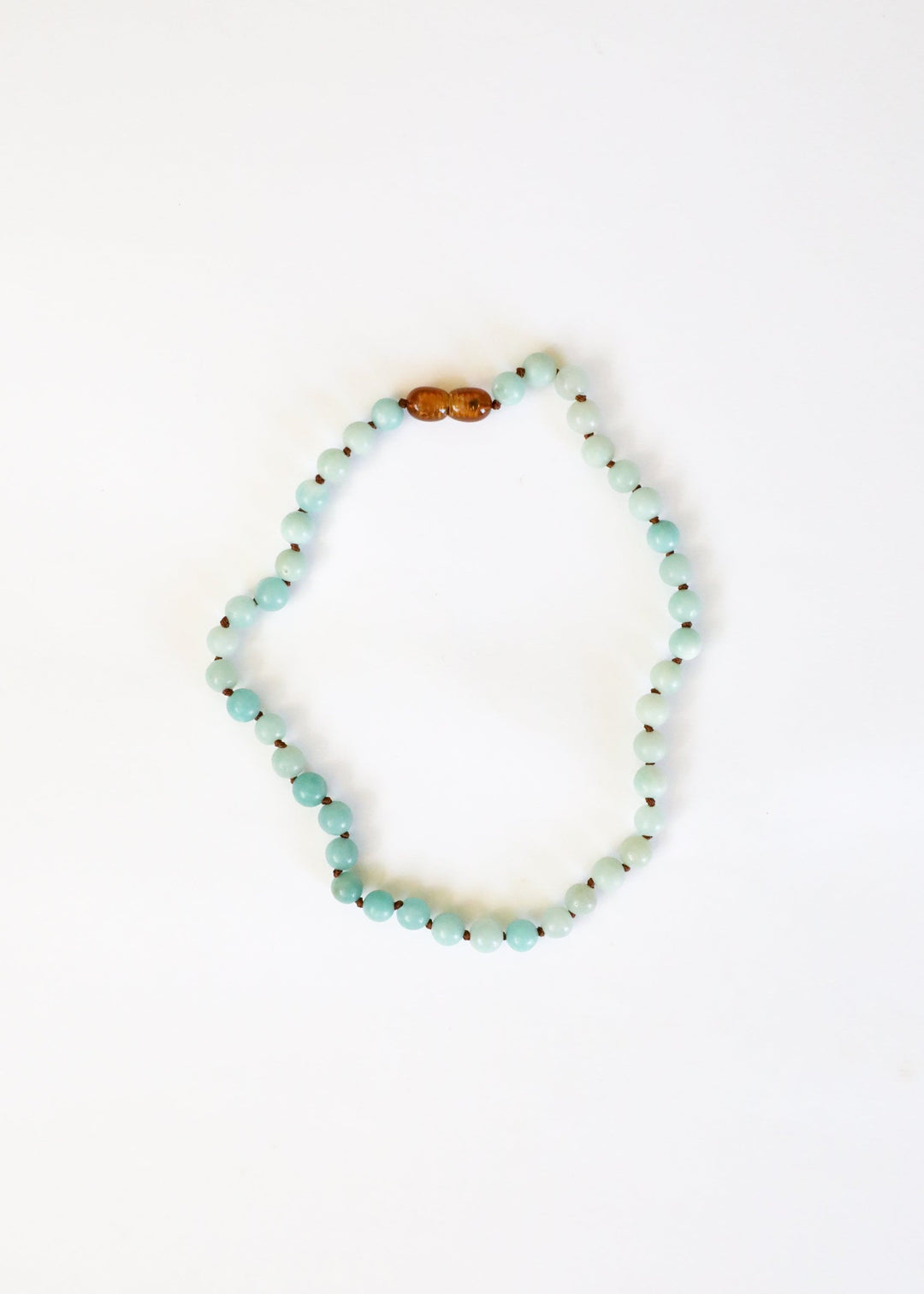 Amazonite beaded necklace with light blue round beads and one amber accent bead