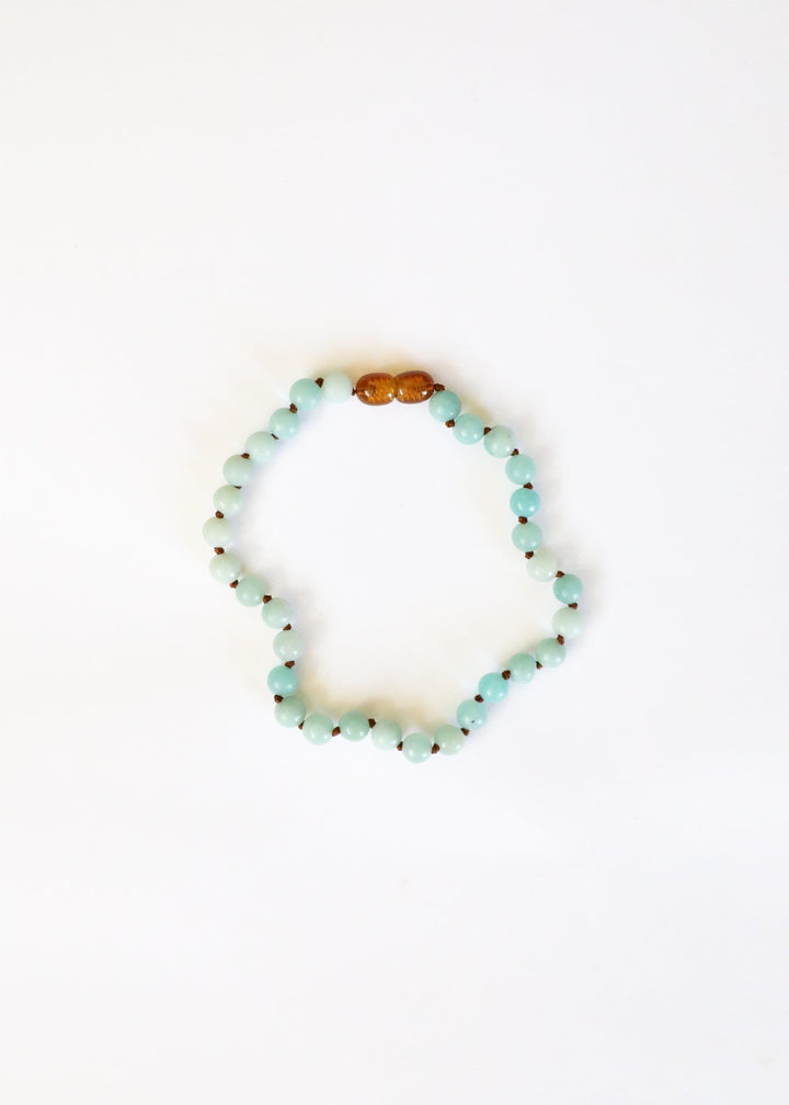 Amazonite beaded necklace with light blue round beads and amber accent bead on top