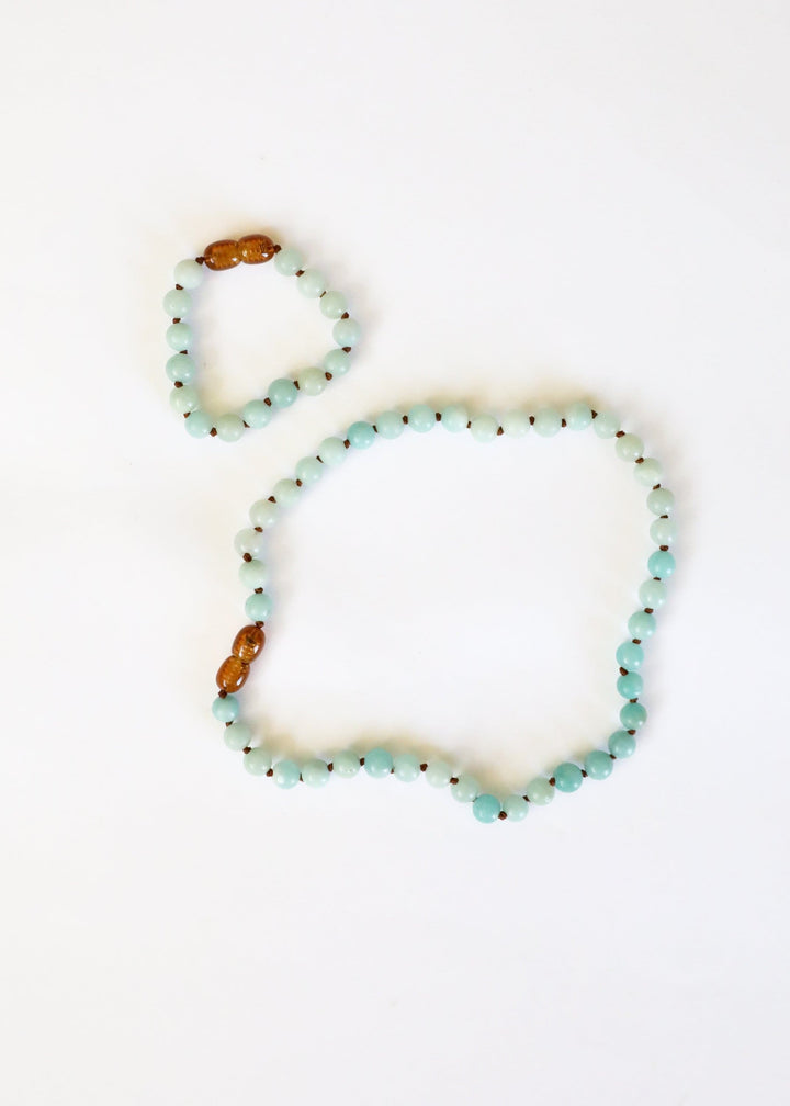Amazonite beaded necklace with light blue beads and two amber accent beads at ends