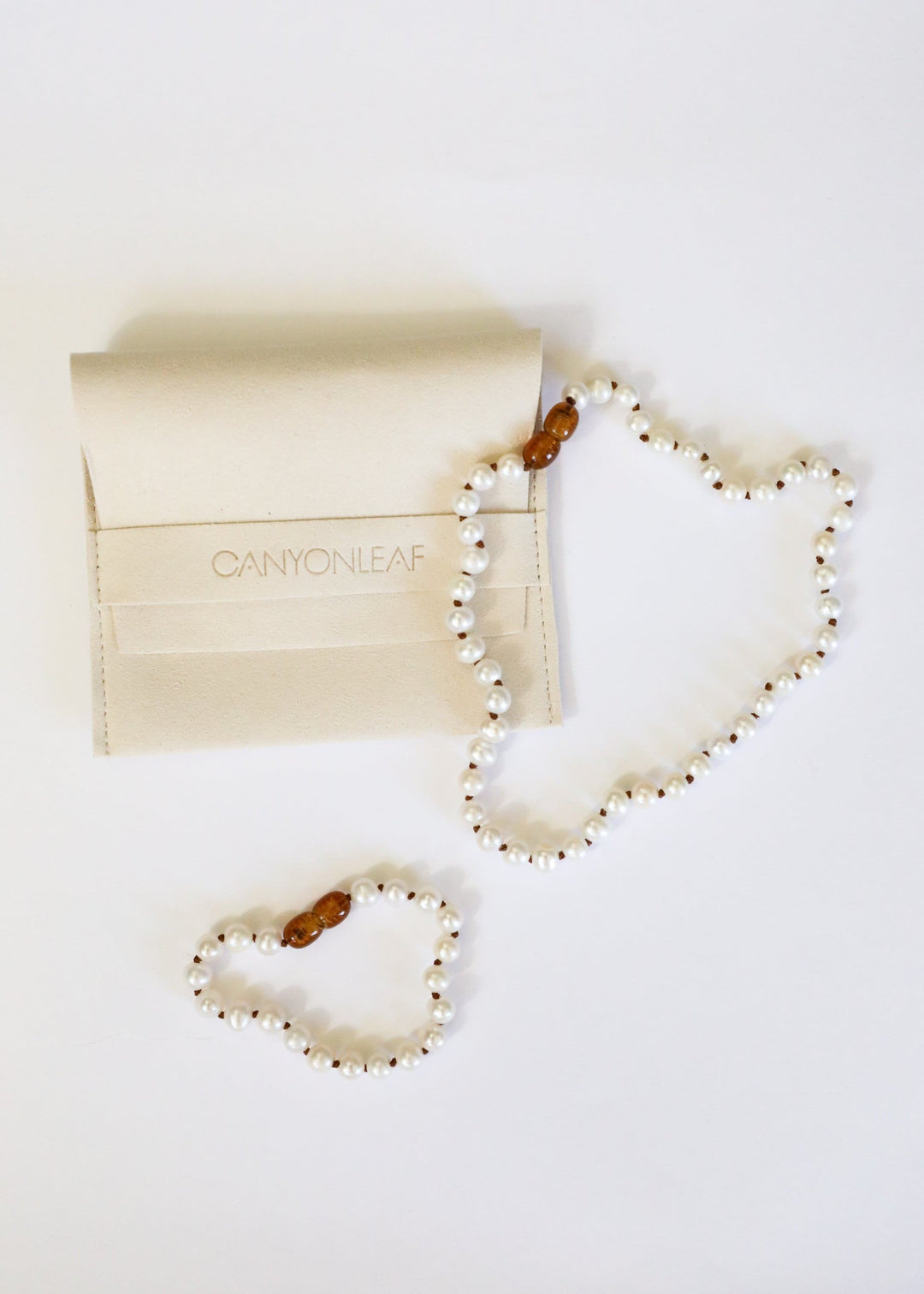 Two heart-shaped pearl and gemstone bead bracelets/anklets in white and brown