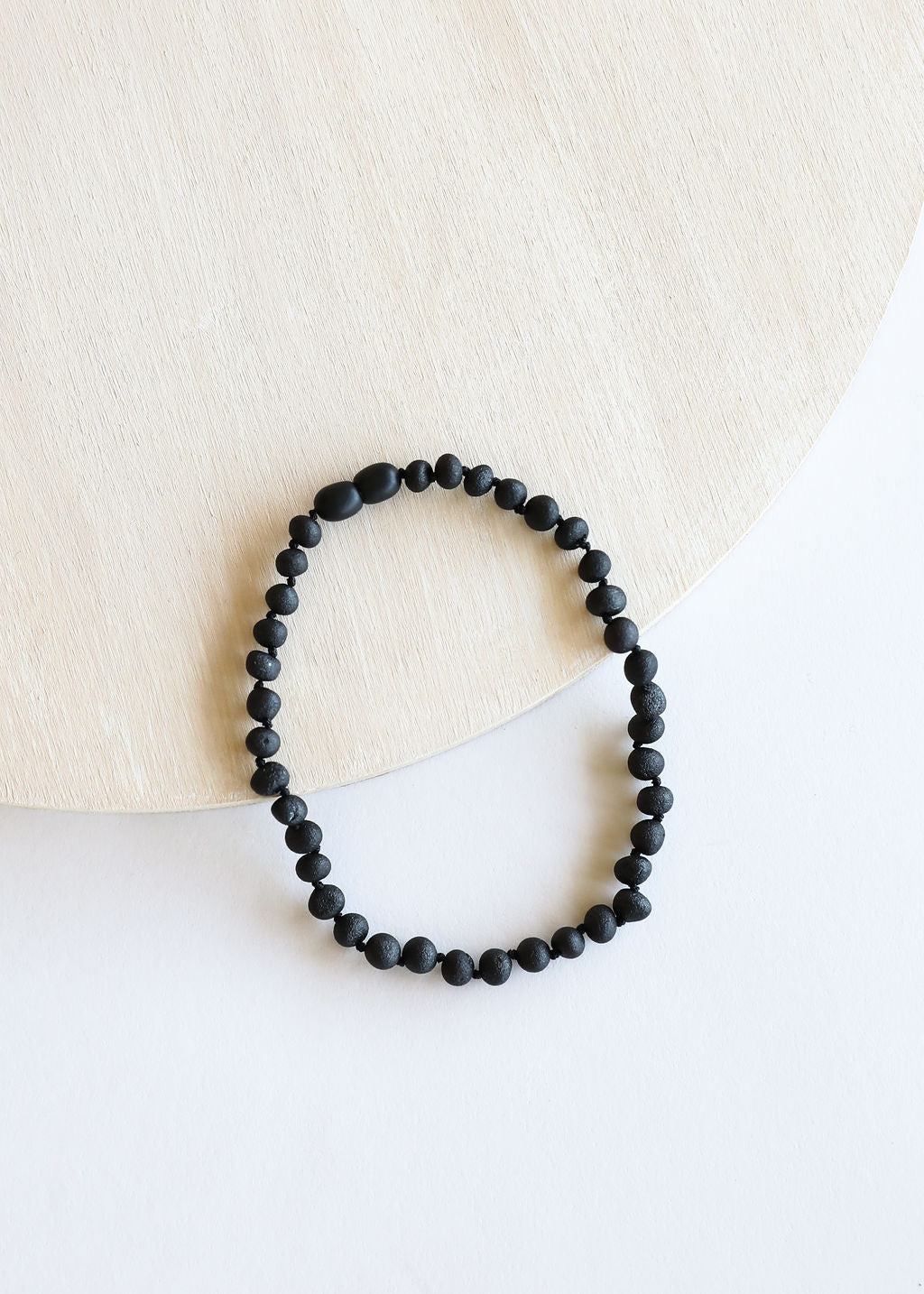 Black amber bead necklace with tightly strung round beads