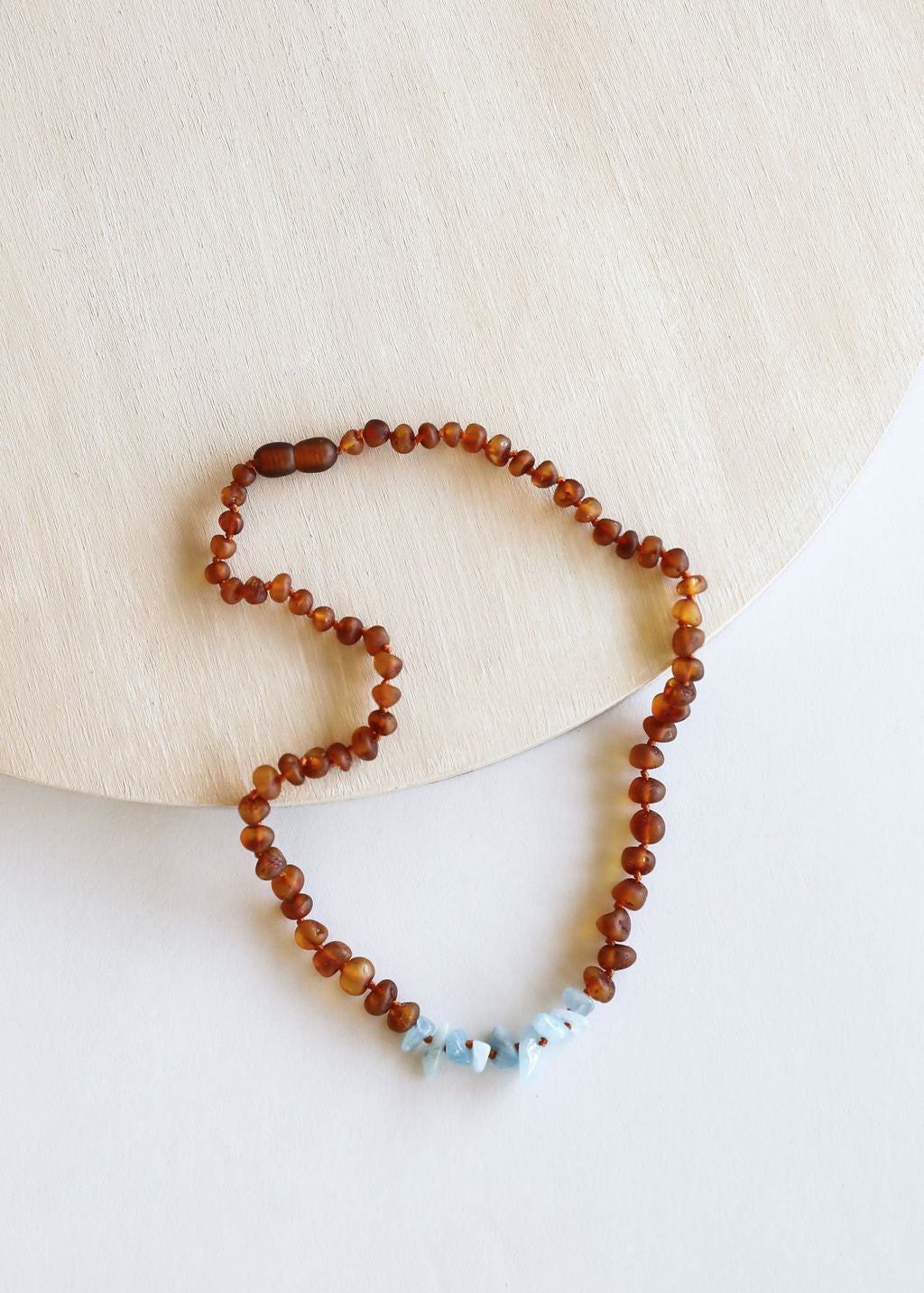 Amber brown bead necklace with light blue stone drops, single beaded strand