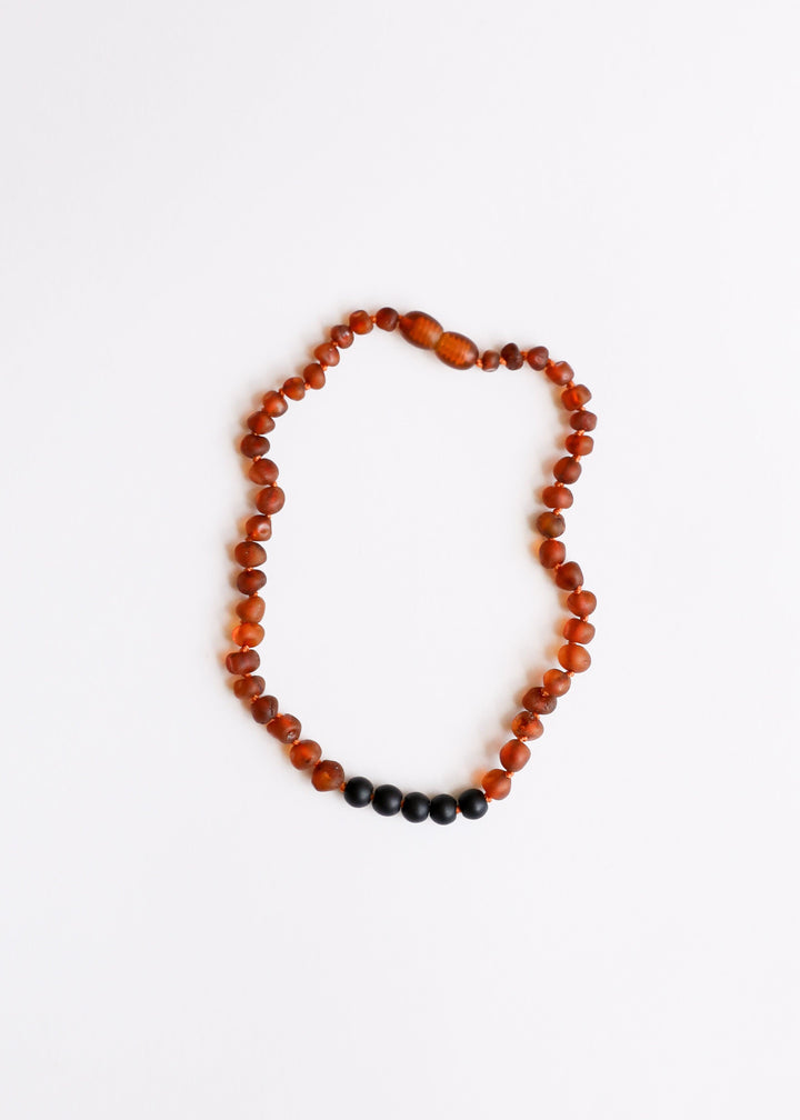 Cognac amber and black bead necklace with a single strand design