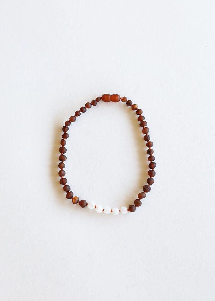 Raw amber beaded necklace featuring small white moonstone beads along the strand