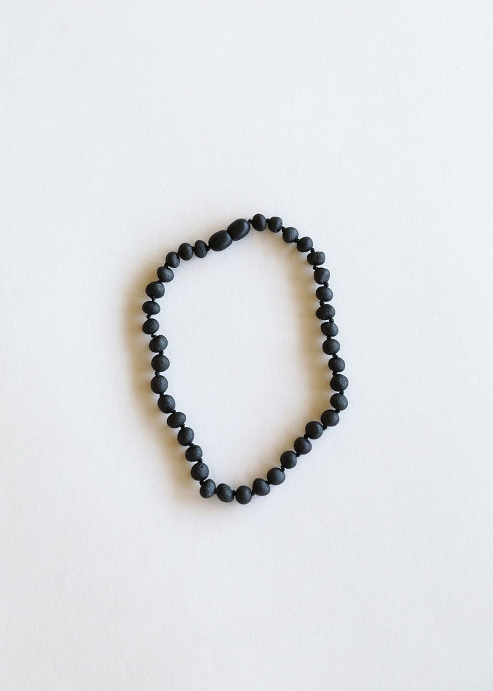 Black amber bead necklace with smooth round dark beads