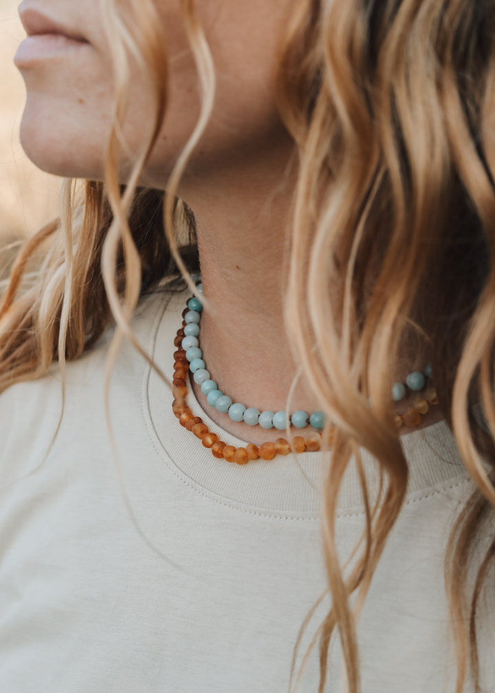 Amazonite beaded necklace with light blue and small amber-colored accent beads