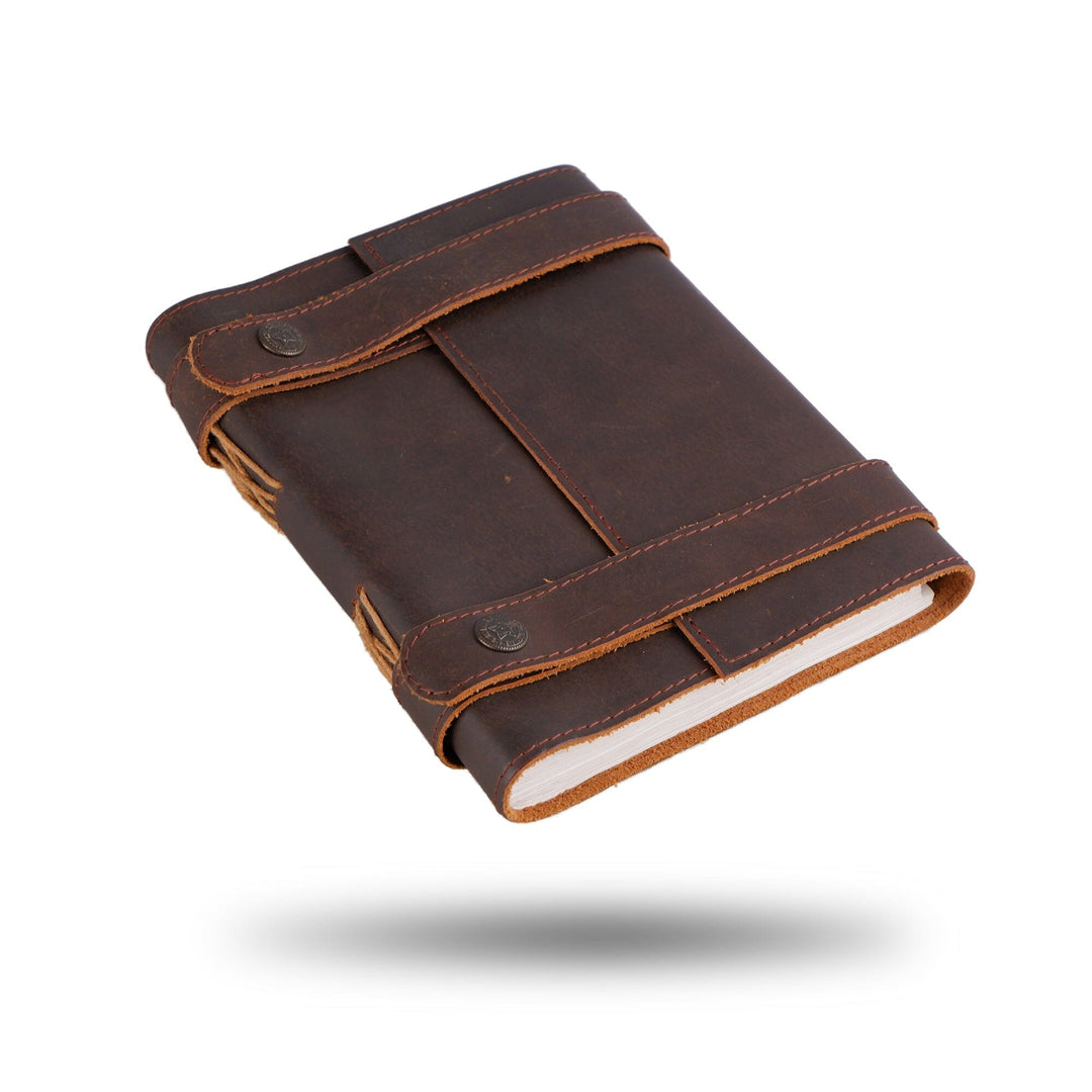 Dark brown leather journal with wrap strap, stitched edges, and open pages