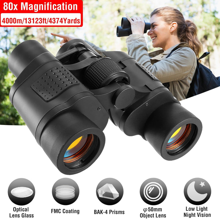 Black binoculars held to eyes outdoors, rubber eyecups and focus knob