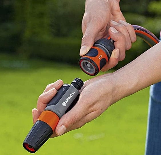 Orange and gray quick-connect hose adapter connected to a garden hose end