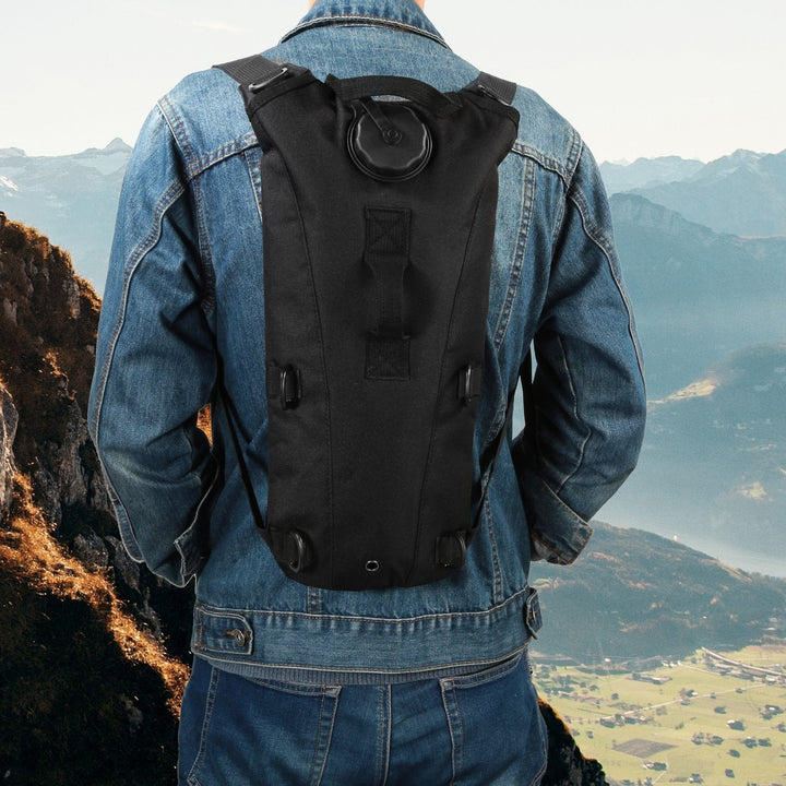 Black hydration backpack worn on a person’s back with chest and shoulder straps