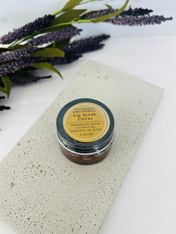 Lip scrub jar labeled Citrus with dark brown scrub and round lid label