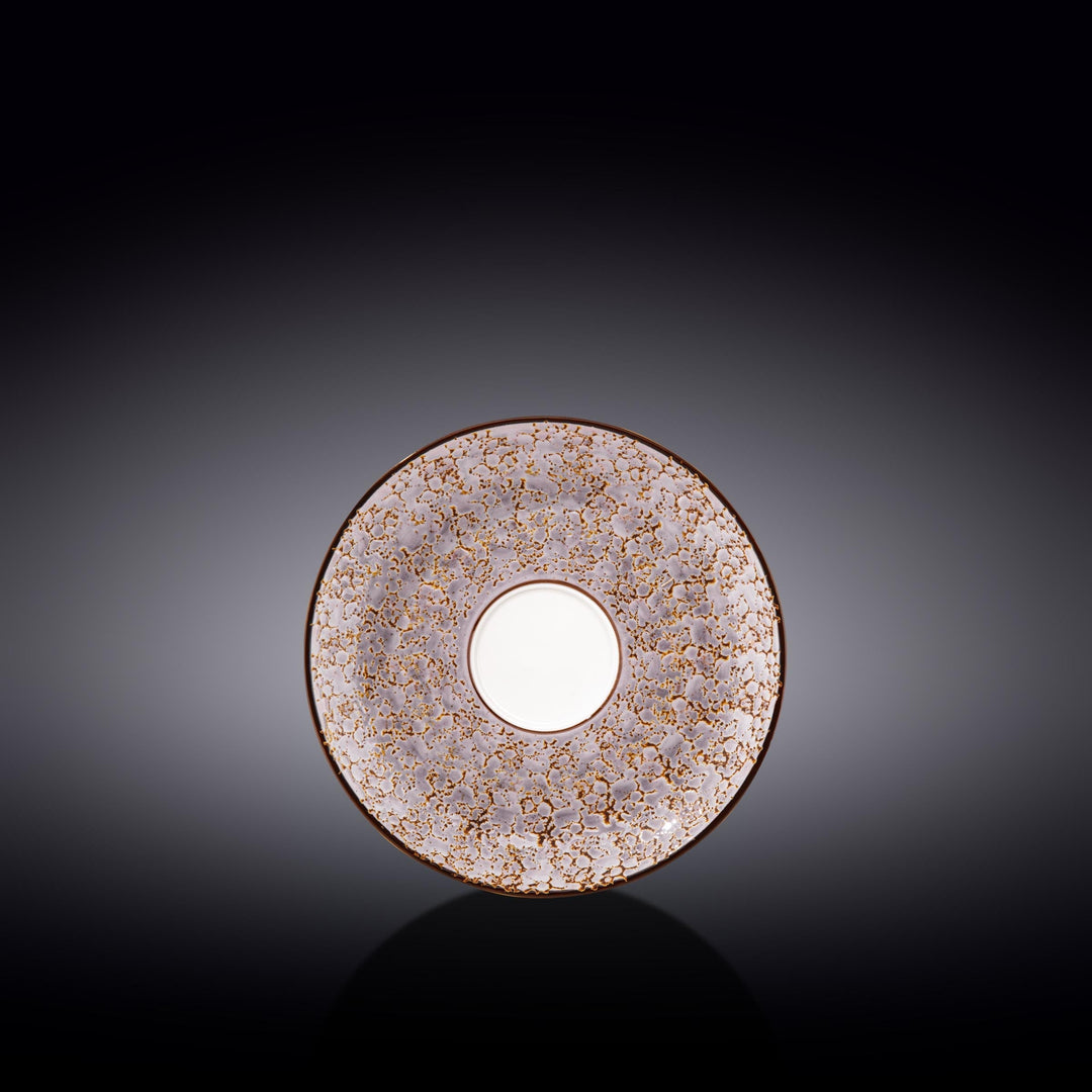 Ornate porcelain saucer with speckled lavender-pink pattern and gold rim