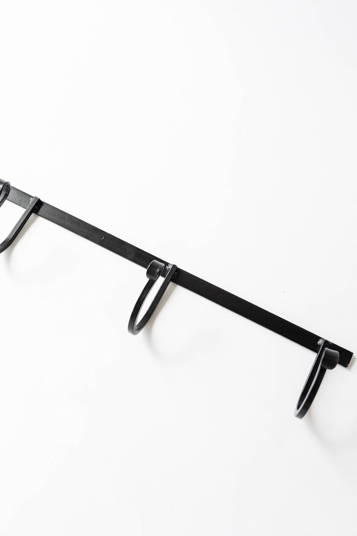 Wrought iron wall rack with two curved hooks, dark finish
