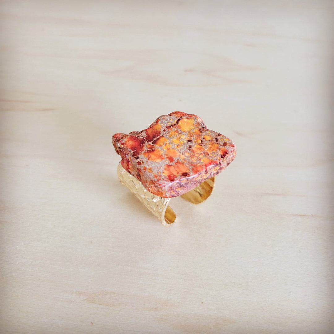 Orange marbled resin statement ring with gold-tone open band and flecks