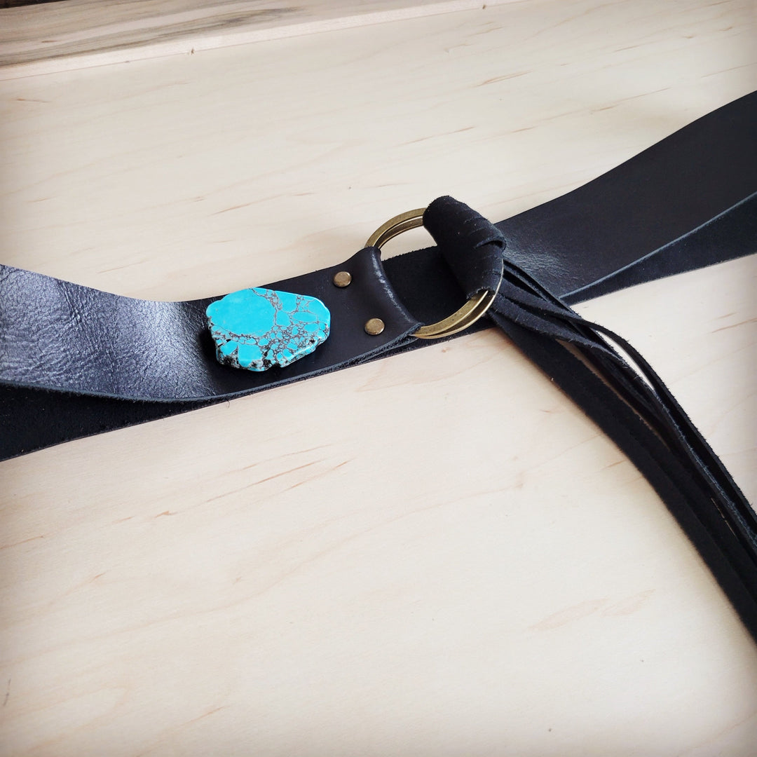 Black leather belt with turquoise slab center and round buckle, long fringe