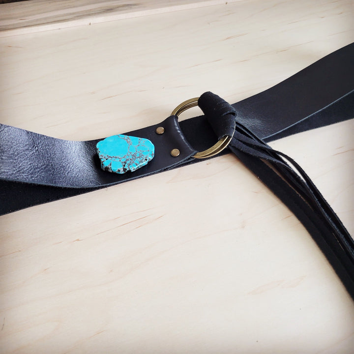 Black leather belt with turquoise slab center and round buckle, long fringe