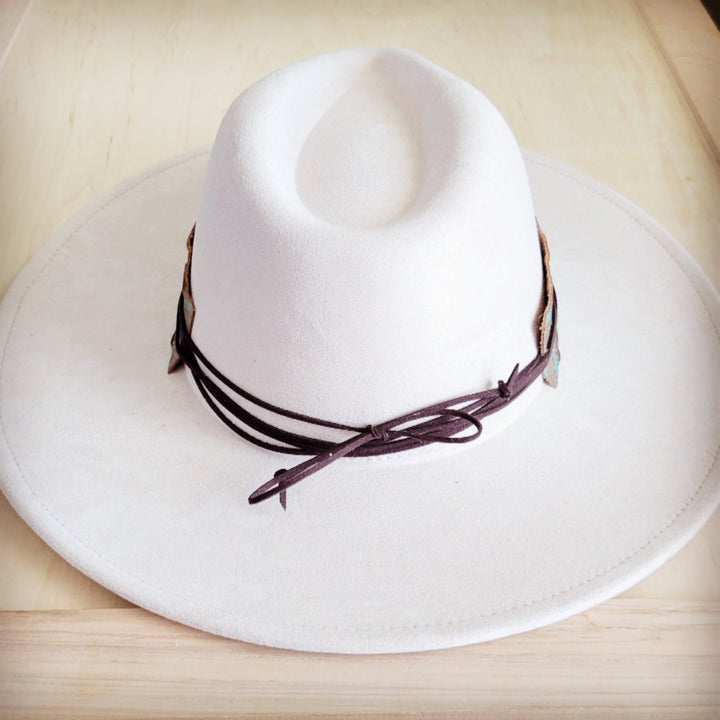 White felt cowboy hat with wide turquoise leather band and visible tie laces at side
