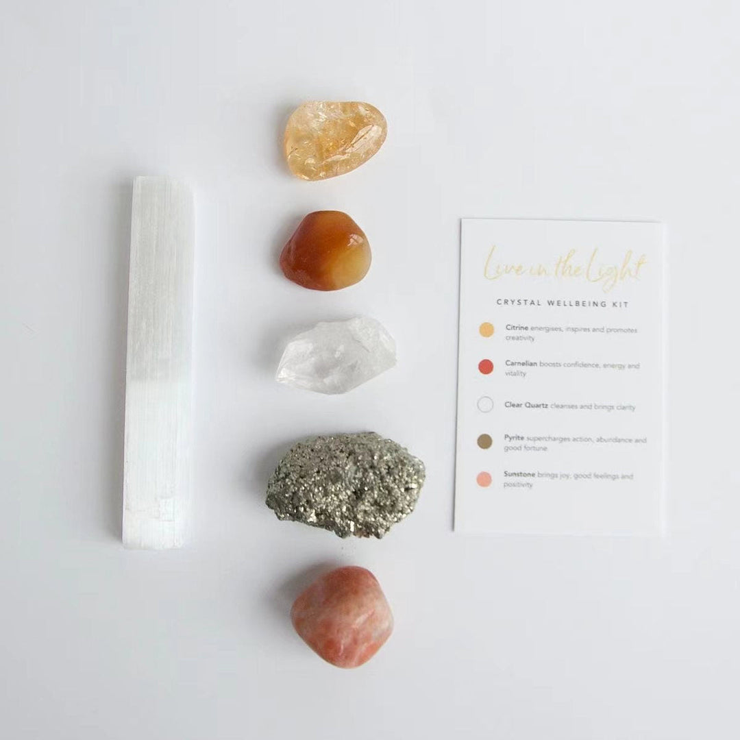 Crystal healing kit with white selenite wand, gold and orange stones, plus instructions card.