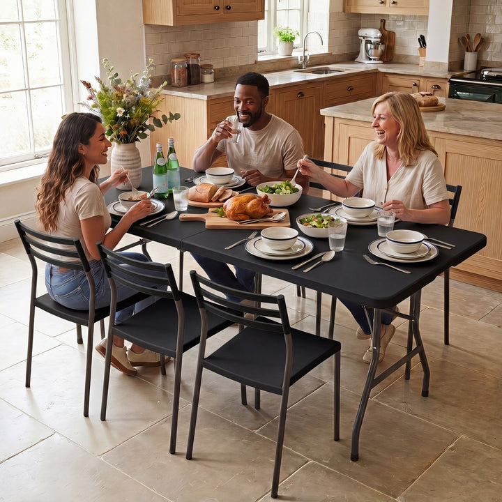 Matte black fold-in-half camping table with rattan-textured tabletop and supporting legs