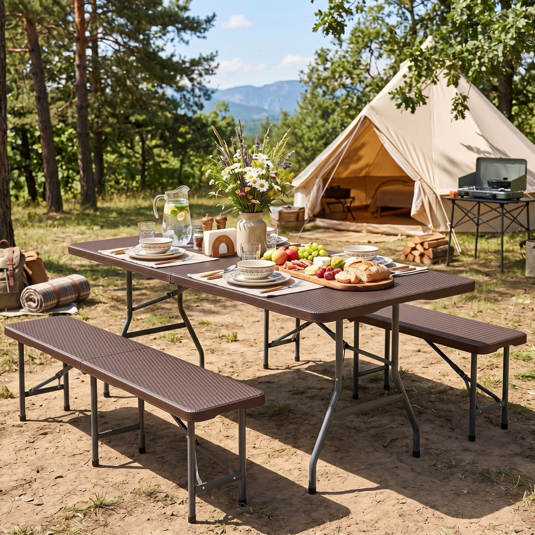 Folding camping table with rattan-texture top and metal legs at campsite