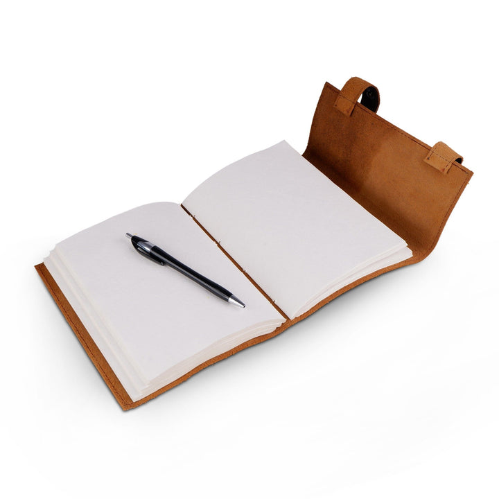Open dark brown leather journal with blank pages and pen in front pocket