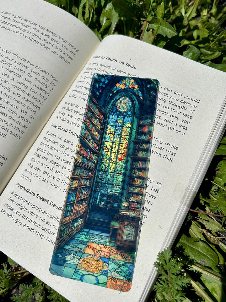 Blue arched cathedral bookmark with stained-glass design, in open book