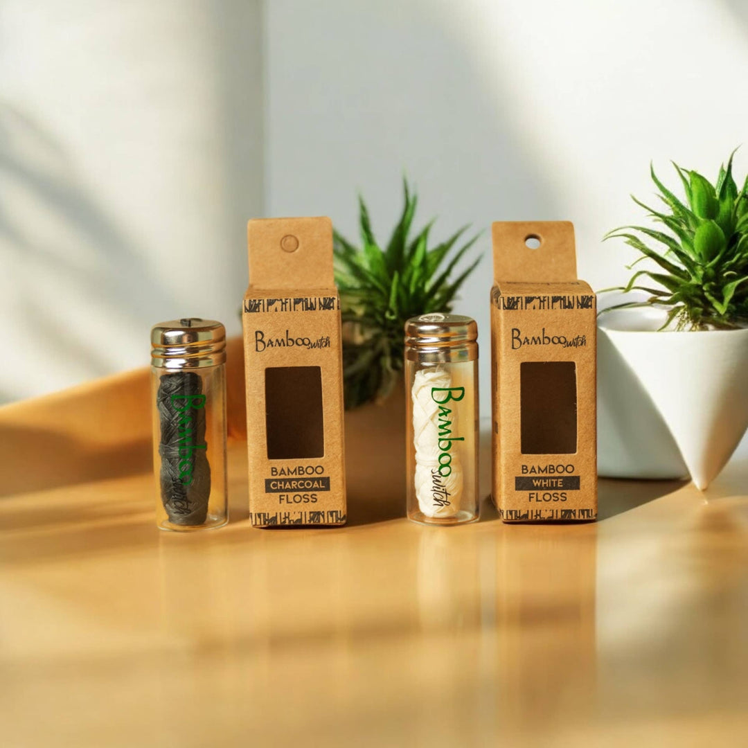 Bamboo floss bundles in cardboard packs, with charcoal and white options shown