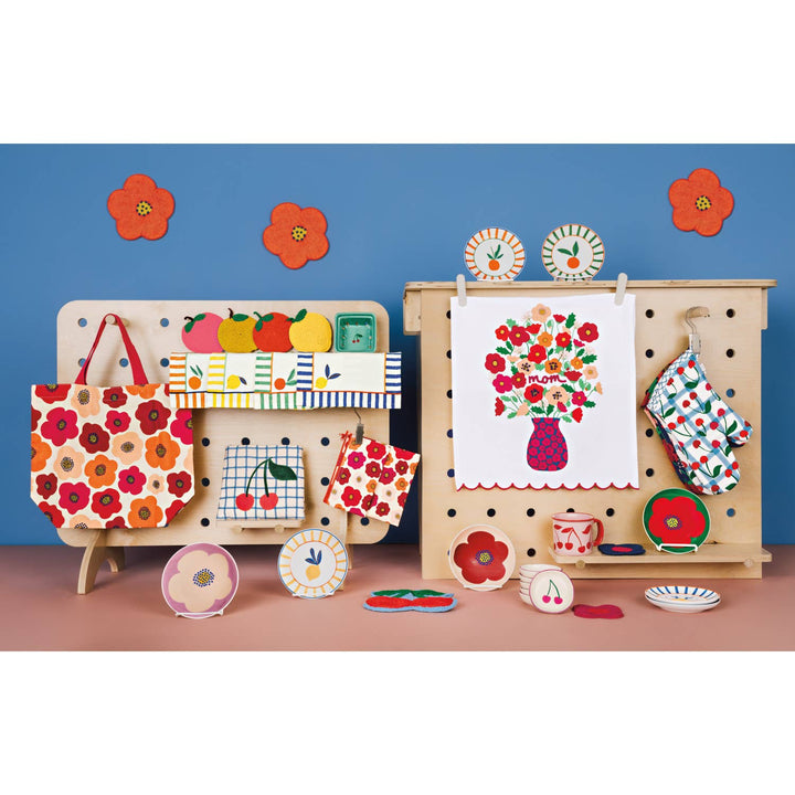 Assorted mini decorative plates with floral, fruit, and stripe patterns on display